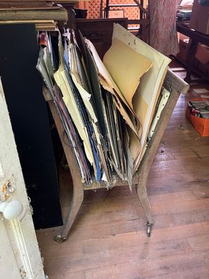 a pile of papers sitting on a chair in a room