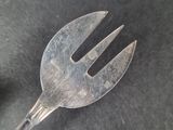 a fork that is sitting on a black surface