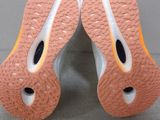 the soles of a pair of tennis shoes on a gray surface