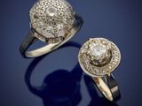two gold rings with diamonds on a blue background
