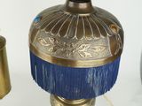 a lamp that has a blue fringe on top of it