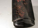 a black case with red flowers on it on a table