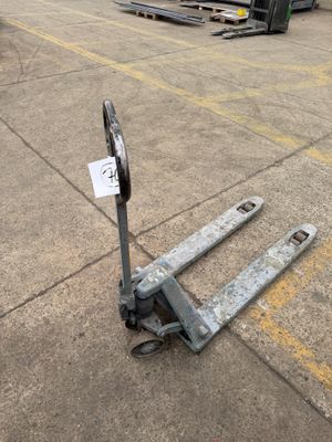 an image of a forklift sitting in a parking lot