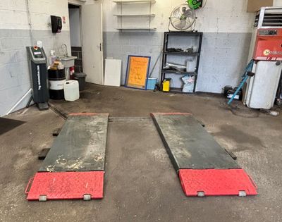 two red and black ramps in a garage