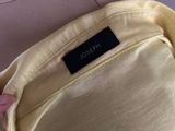 the back of a woman ' s dress with a label on it