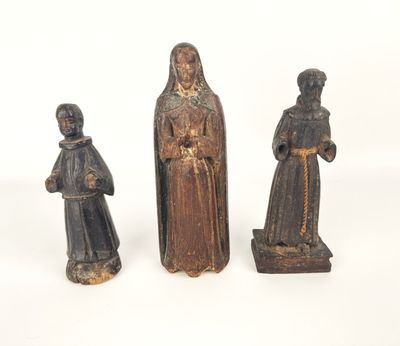three wooden figurines of a woman and two men