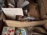 a box full of books and other items on a table