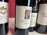 several bottles of wine are lined up on a table
