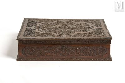 an old wooden box with ornate carvings on the lid