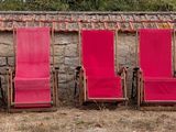 many chairs that are lined up against a wall