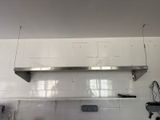 a picture of a kitchen with a stainless steel shelf above the stove