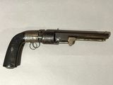 an old gun that is on a white surface