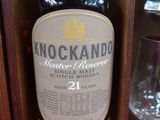une bouteille de Knockando à côté d'un verre de vin