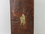 brown leather case with a picture of a woman on it