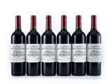 four bottles of red wine are lined up in a row