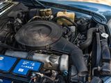 a blue car with a blue battery in the engine bay