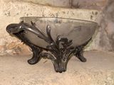a silver bowl sitting on top of a stone step