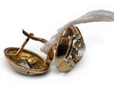 a gold plated object with a diamond in it