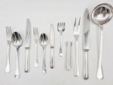 a lot of silverware on a table with a spoon and fork