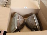 two pieces of luggage sitting in a box on the floor