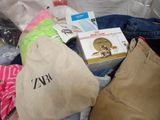 a bag full of clothes and other items that are on the floor