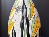 a vase that is sitting on a table with a black background