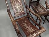 pair of antique wooden folding chairs with hand painted designs on them