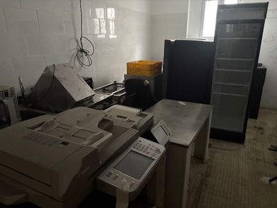 a room with a bunch of office equipment on the floor