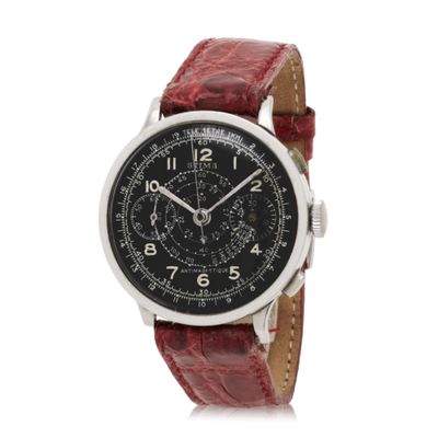 a close up of a watch on a white background with a red strap