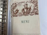 a picture of a menu in a binder on a table