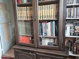 a book case with many books on it in a room