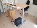 a computer desk with a monitor and a keyboard on top of it