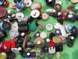 many different types of buttons on a green surface
