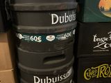 several beer kegs stacked on top of each other in a room