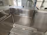 a stainless steel kitchen with a sink and a dishwasher in it