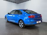 the rear end of a blue car in a showroom