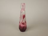 a glass vase with a pink flower inside of it