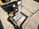 a small cart with a seat that is sitting in the dirt