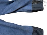 a pair of blue jeans with black trims on them