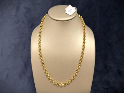 a gold necklace on a mannequin with a tag on it