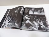 an open book with a picture of a band on it