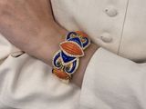 a person wearing a bracelet with a design on it