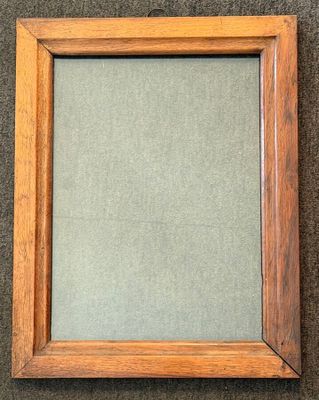 an old wooden frame with a green background