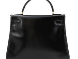 a black leather handbag on a white background