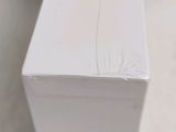 a white box sitting on the floor next to a toilet