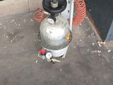 a propanent sitting on the floor next to a fire hydrant