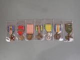 five medals and a medal in a plastic case