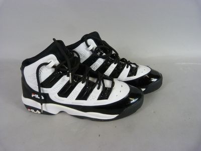 a pair of black and white sneakers on a white surface