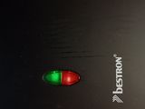 a close up of a black laptop with a red light