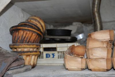 baskets and pans on a shelf in a kitchen